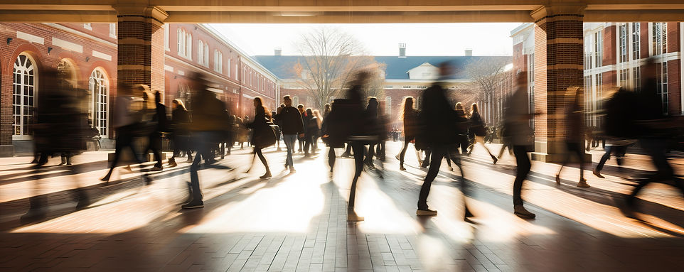 Image of students walking on campus. Photo is somewhat blurred 