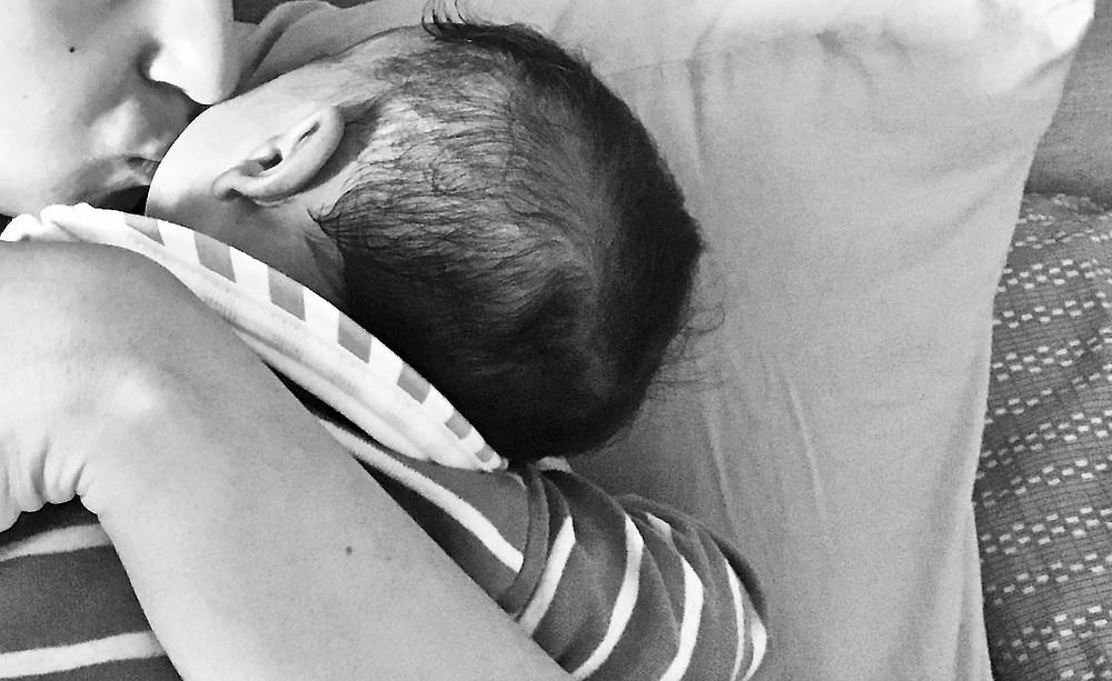 Mother kissing her newborn