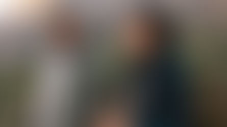 Two people walking outdoors, smiling and talking together, showing how supportive connection ties love and mental health to everyday well-being.