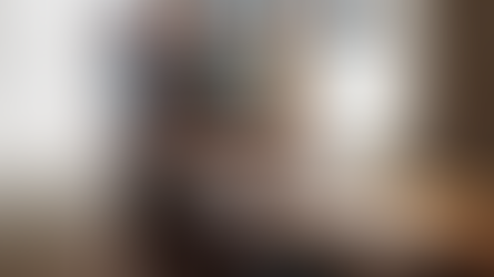 The Power of Self-Reflection — person writing in a journal at a sunlit table beside an open book and a coffee mug by a window.