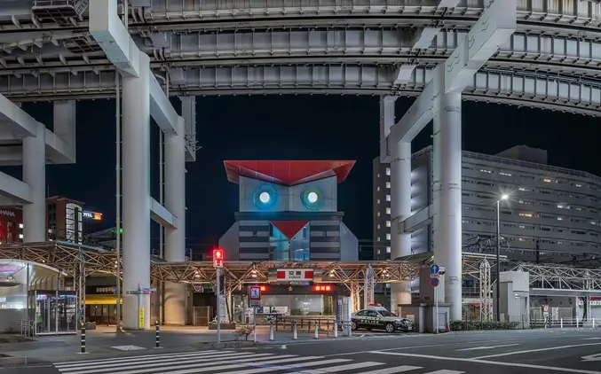 Night view of owl-shaped Koban police box in Chiba, Japan with urban highway structure