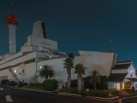 Night view of the Tokyo Maritime Museum in Odaiba with illuminated ship-like architecture and geometric design, captured by photographer Nicolas Wauters.