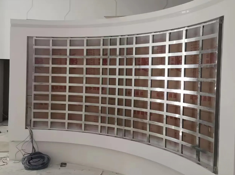 Seamless curved display formed by flexible LED modules during installation.
