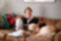Woman smiling on couch with Golden Retriever