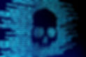 Computer code on a screen with a skull r