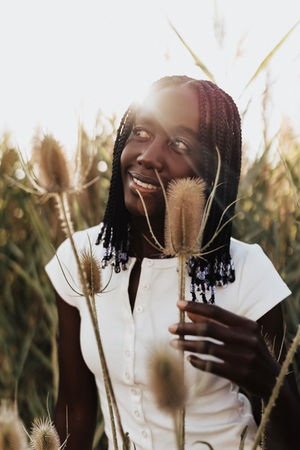 Natural light portrait photography session in Utah featuring dramatic blue skies and golden summer fields.