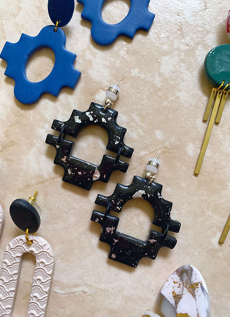The Clay Atelier flatlay of clay earrings on top of tile