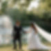 Bride and groom walking hand-in-hand past a scenic lakeside fountain during a DFW wedding venue portrait session, planned by Lasting Events and captured by Anya Joy Photography.