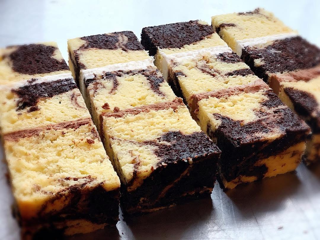 Slices of marbled chocolate and vanilla cake with creamy filling