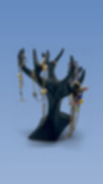 Black tree-shaped jewelry stand holding necklaces and bracelets