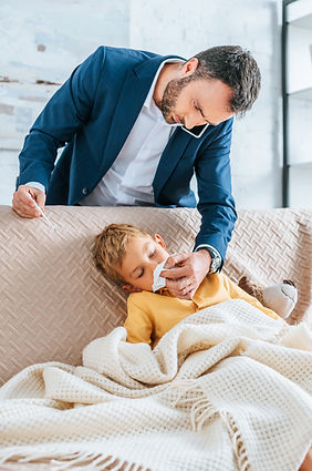 Man caring for child on couch, showing emotional support and family-work balance