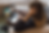 macbook-mockup-of-a-woman-working-on-a-sofa-a21507.png