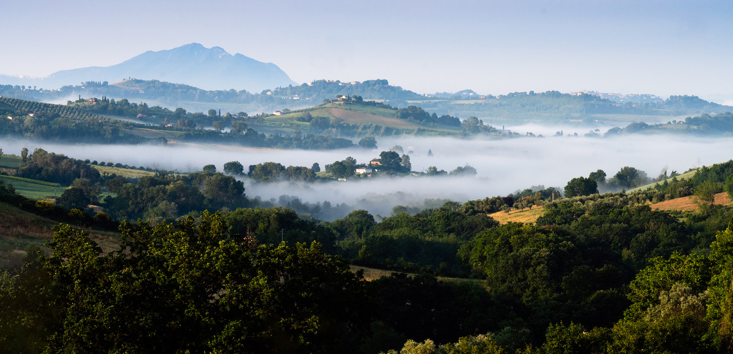Morning mist lies over the hills of Umbria