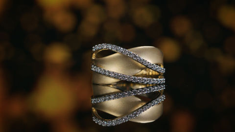 Gold and diamond ring with starry background.