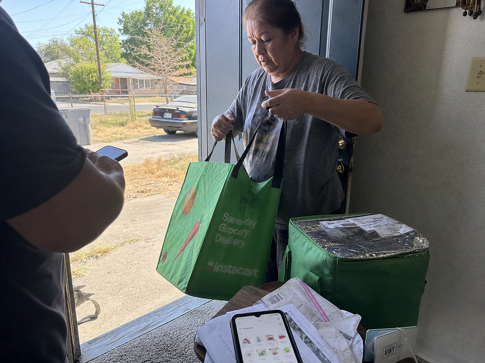 A warm afternoon in Modesto, as a woman gratefully receives her grocery delivery at the front door, embodying convenience and comfort without leaving home.
