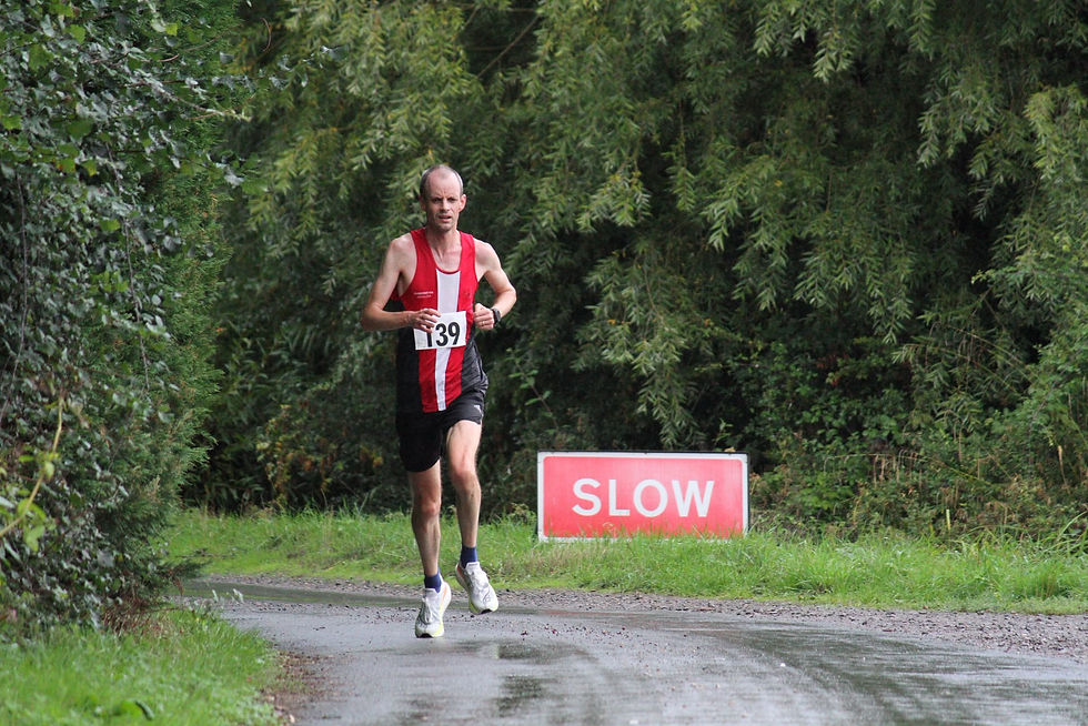 Bill Leggate at 2026 Angels 10k with badly placed sign