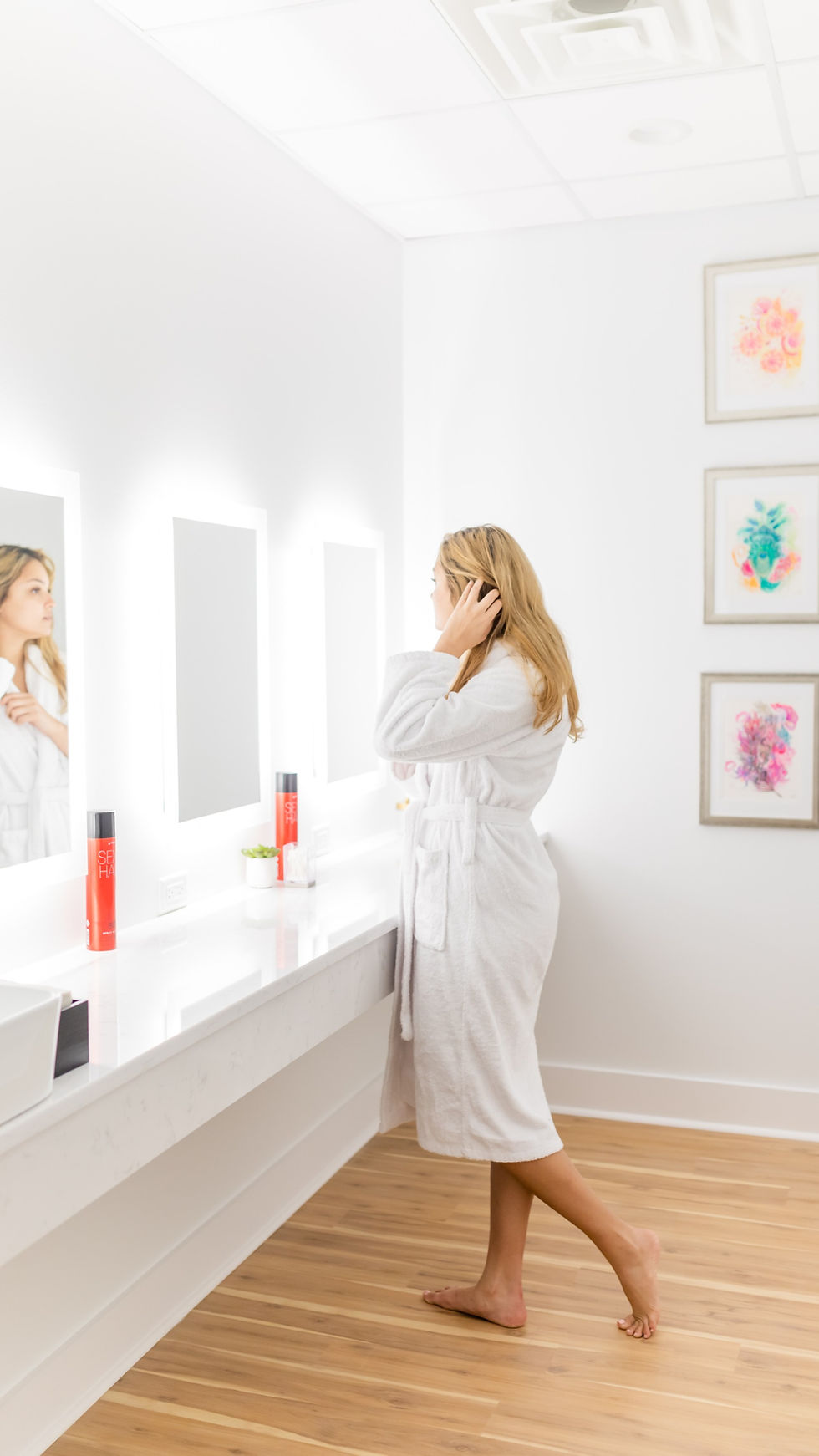 woman looking in mirror in hair and makeup room