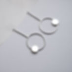 Silver earrings, geometrical forms, minimalist design, fashion accessories.