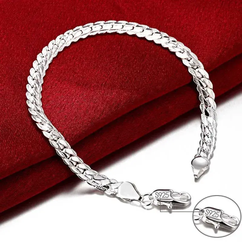 Thumbnail: Sterling silver flat curb chain bracelet styled alongside a watch for a modern look