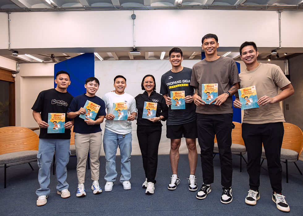 A group of athletes and the author posing together while holding copies of the children’s book ‘Nanay! Bakit Hindi Ako Maka-Poop?