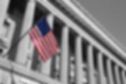 Government building with USA flag out front.