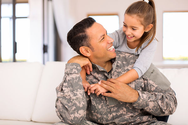 Military man smiling with daughter