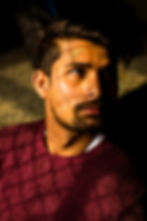 Man in maroon sweater with forehead injury