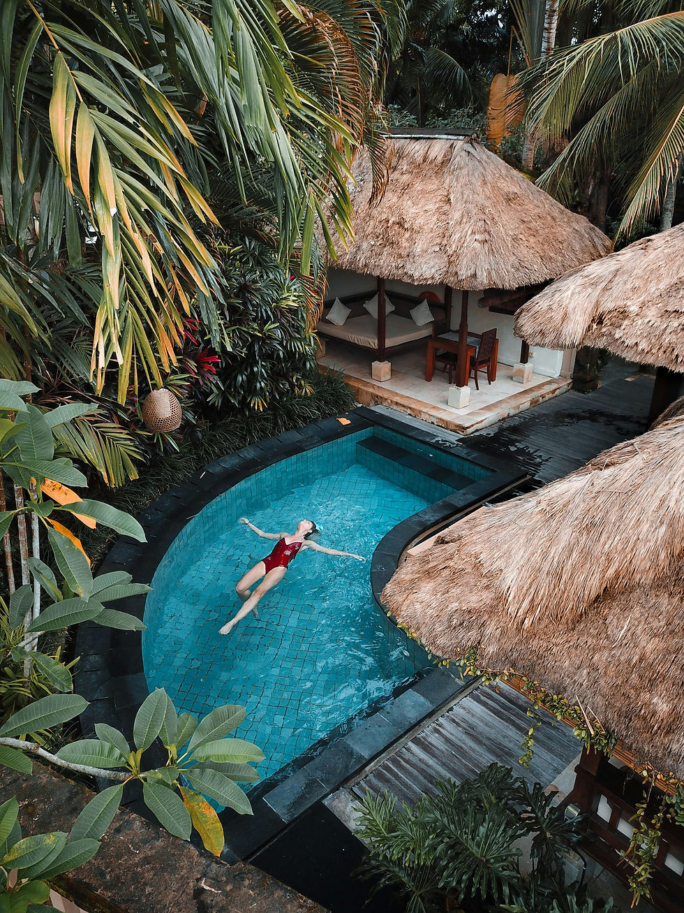 Woman relaxing in tropical resort pool