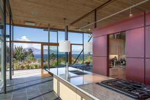 Interior living space of Glass House with floor-to-ceiling windows toward landscape