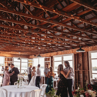 Group dancing in waterside pavilion