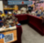 Vintage pottery, glassware, and collectibles displayed at a vendor booth