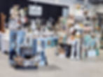 Vintage home décor, candles, signs, and collectibles displayed at a vendor booth