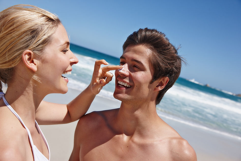 A woman is applying sunscreen lotion to the nose of a man, emphasizing the importance of protecting the skin from the sun's harmful UV rays.