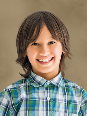 School photography service portrait of a young girl on a beige Sandstone background — family personalization shown
