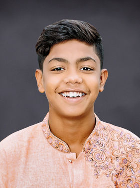 Student portrait of a young boy on a dark gray Slate background for virtual school directory use
