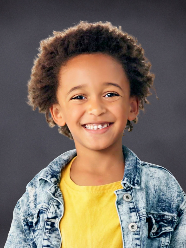 Student portrait with a dark gray textured studio background.