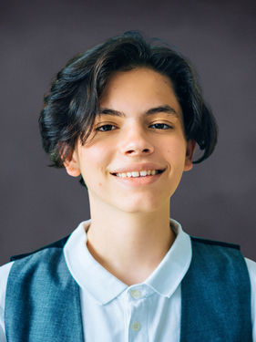 Virtual school portrait of a young boy on a dark Slate gray background by Instant School Photos