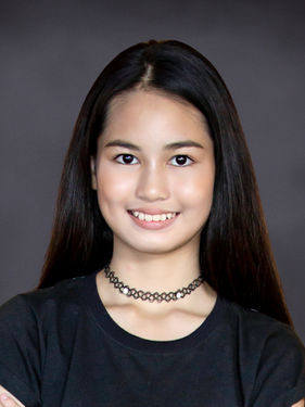 Student ID photo of a teenage girl with long dark hair on a dark gray Slate background by Instant School Photos
