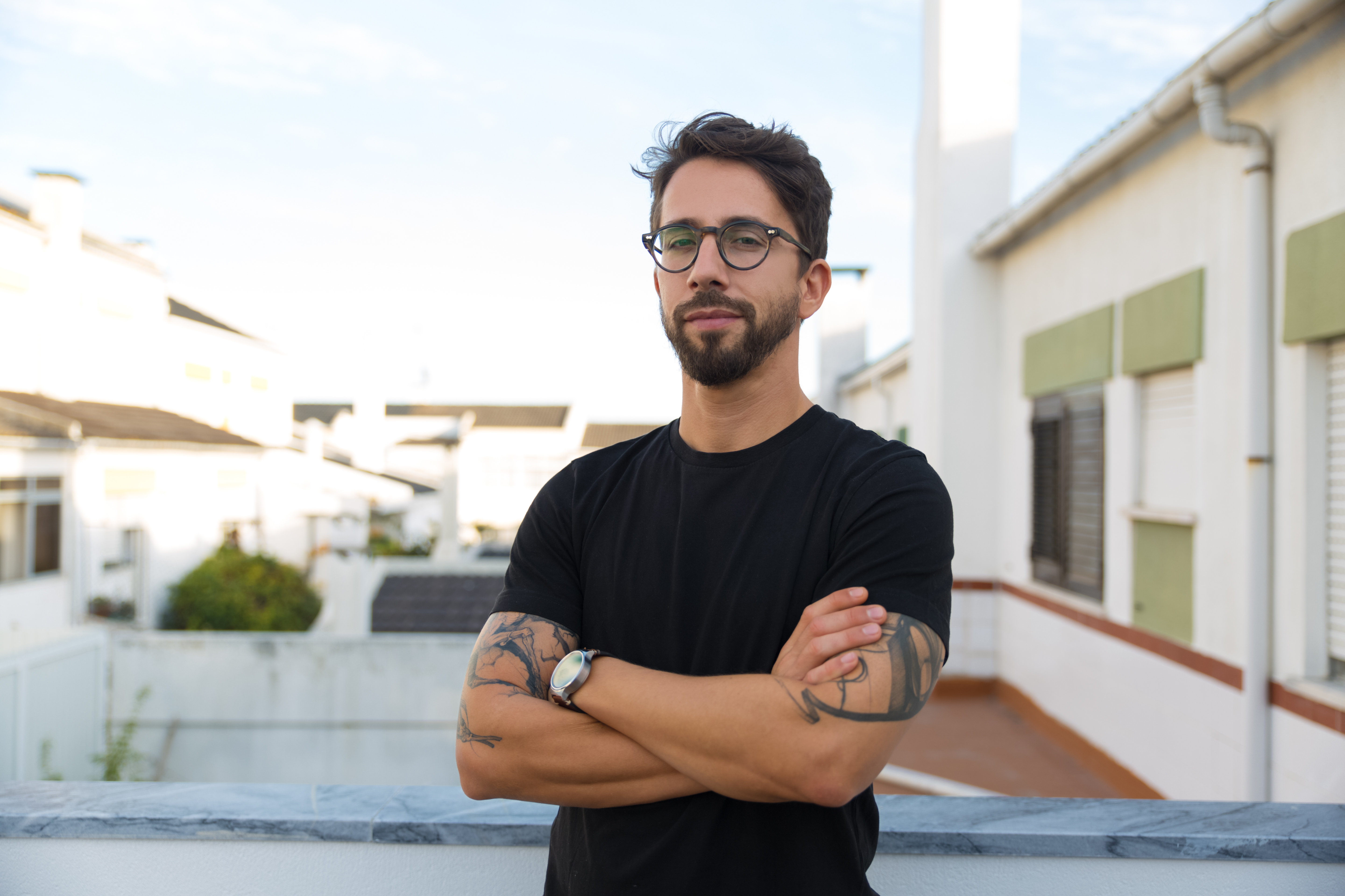 confident-stylish-guy-with-tattoos-posing-apartment-balcony.jpg
