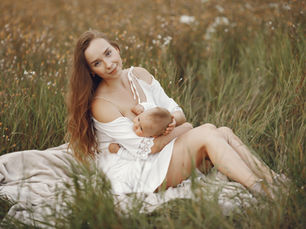 Woman calmly breastfeeding baby in field symbolizing choice in mental health care 