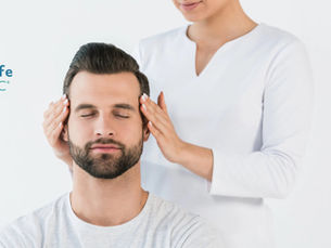 Reiki practitioner treating a client in a clinical setting 