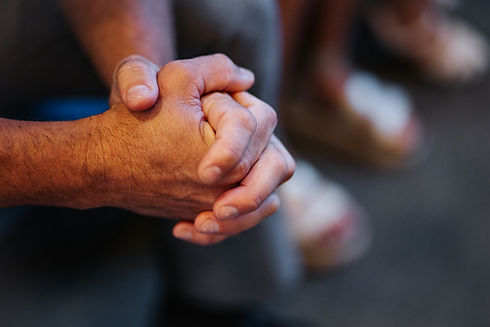 Hands clasped in prayer during a worship service at First Baptist Church Ocean Springs