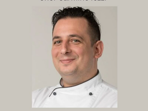 Chef Carmine Iezzi, smiling, professional portrait for Hospitality Chain feature.