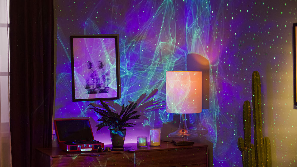 Bedroom scene lit by an aurora projector