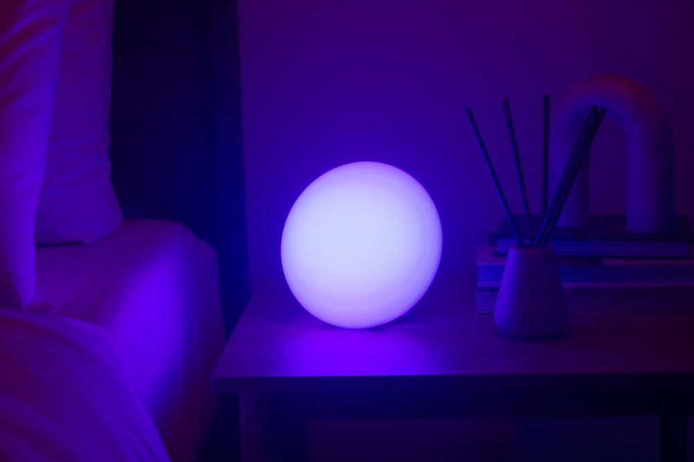 Galaxy projector casting stars across a bedroom