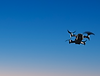 Drone in flight with a blue grae sky in the background