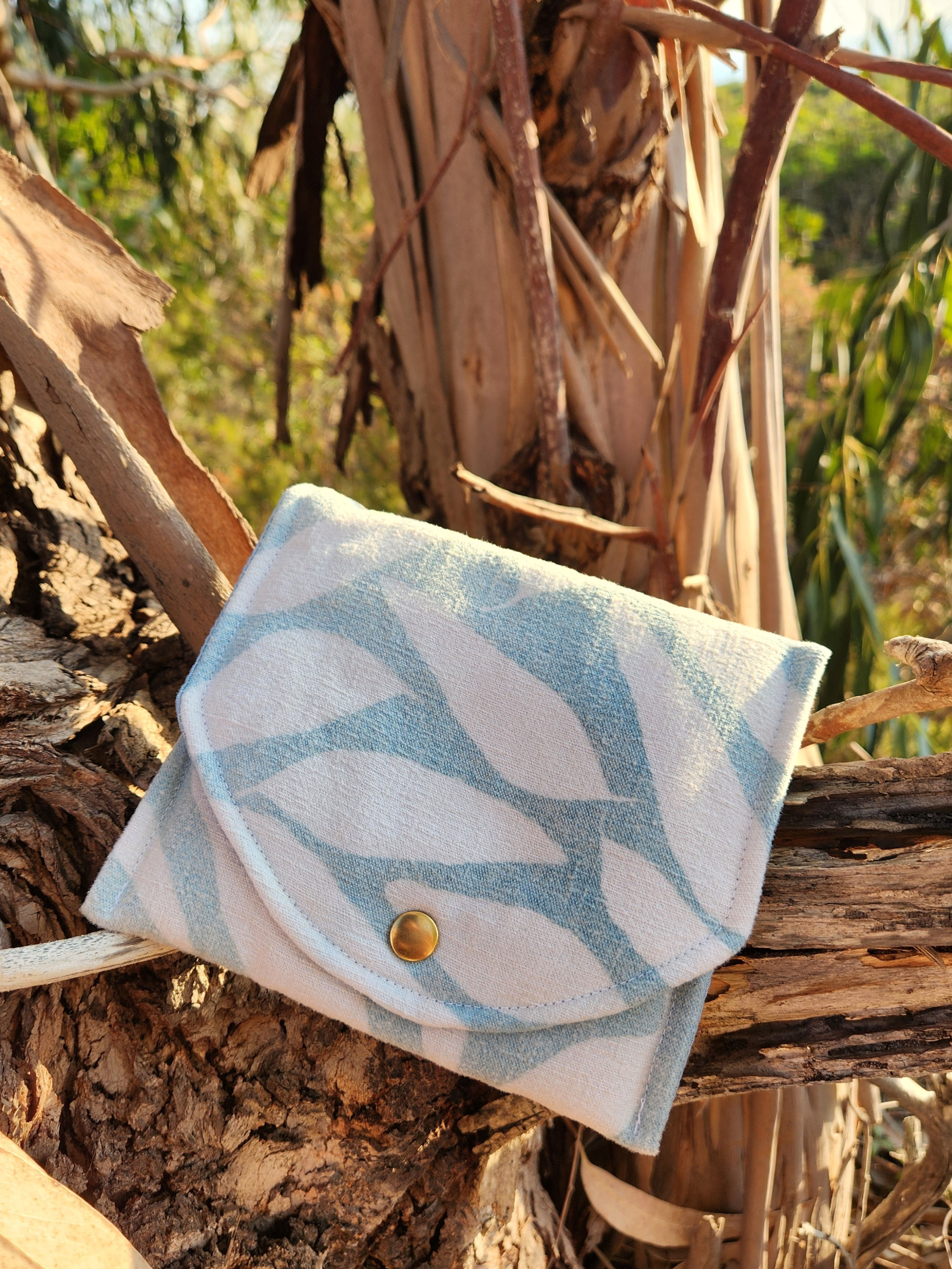 Pochette à pression en lin bleu denim clair imprimée d'une feuille d'eucalyptus Marjuti.