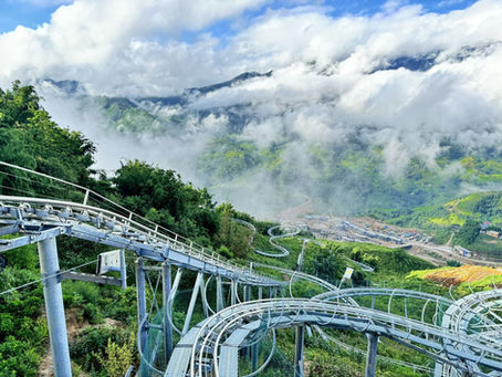 Alpine Coaster rail among clouds and mountains