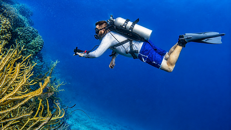 Diver practising trim and buoyancy control during a PADI Peak Performance Buoyancy course while scuba diving in Mahahual.