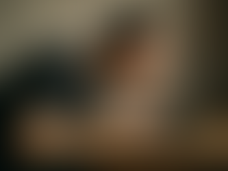 Man hunched over a laptop with his head close to the screen